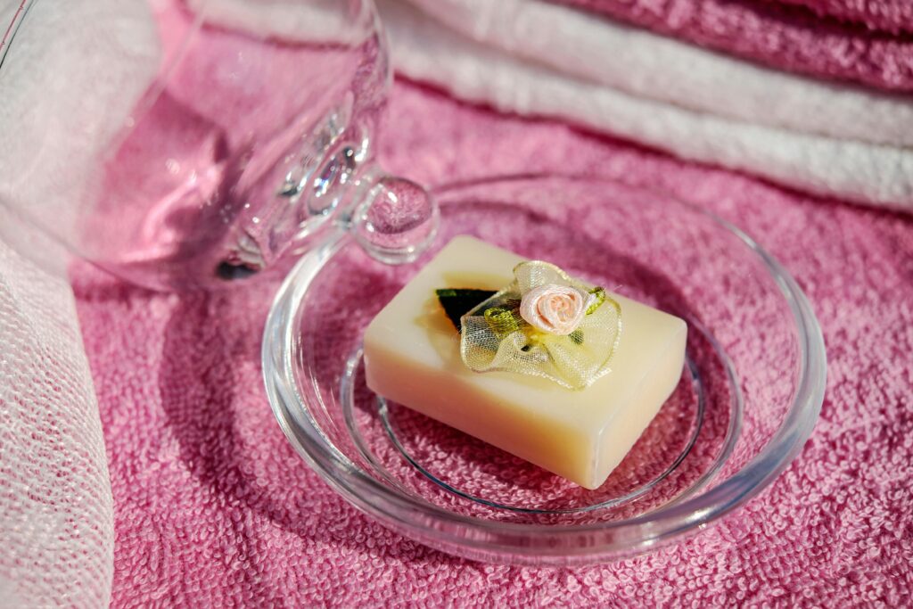 Handcrafted luxury soaps displayed on a marble tray in a spa setting